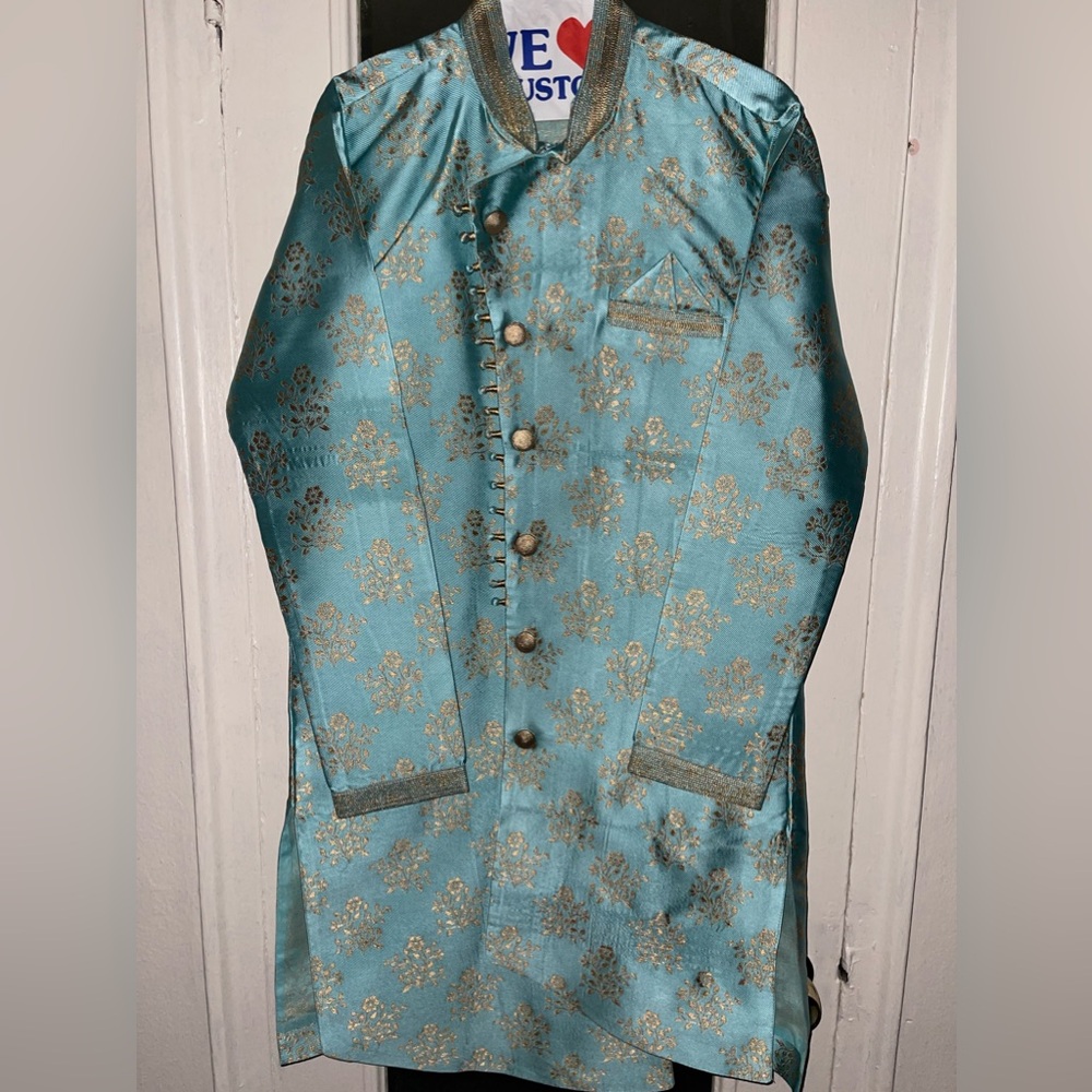 Light blue and gold colored sherwani set with gold matching pants.